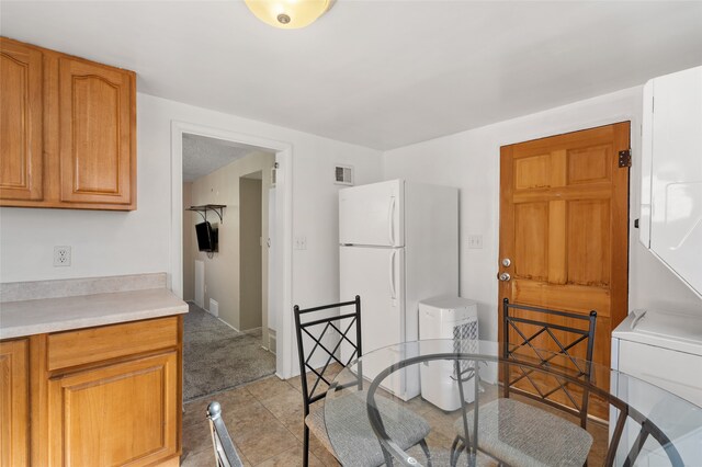 dining room with stacked washer / drying machine and light tile patterned flooring