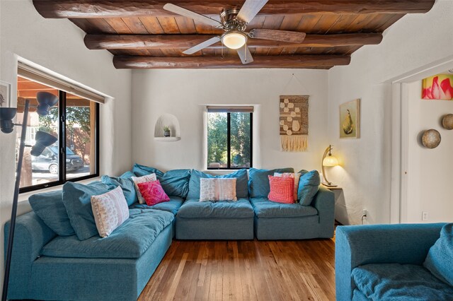 living room with wood ceiling, ceiling fan, and beamed ceiling