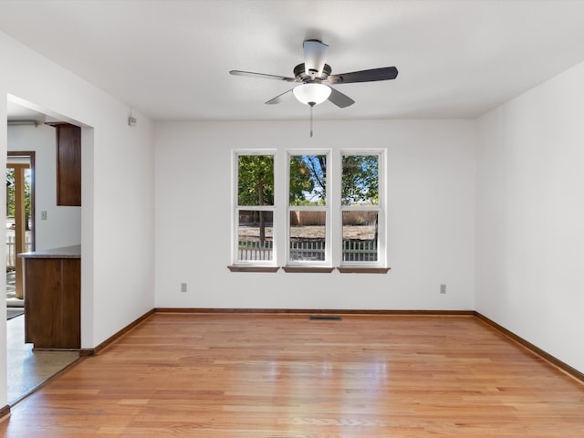 spare room featuring light hardwood / wood-style floors and ceiling fan