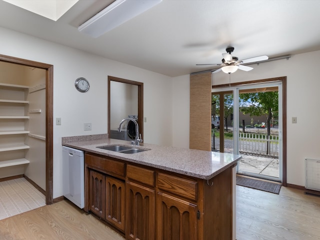 kitchen with dishwasher, light wood-type flooring, ceiling fan, and sink