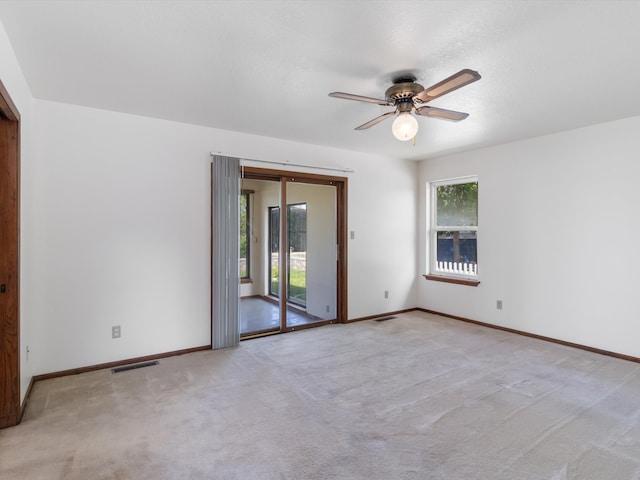 carpeted empty room with ceiling fan