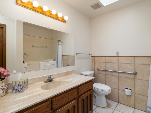 full bathroom featuring vanity, tile patterned flooring, toilet, shower / bathtub combination with curtain, and tile walls