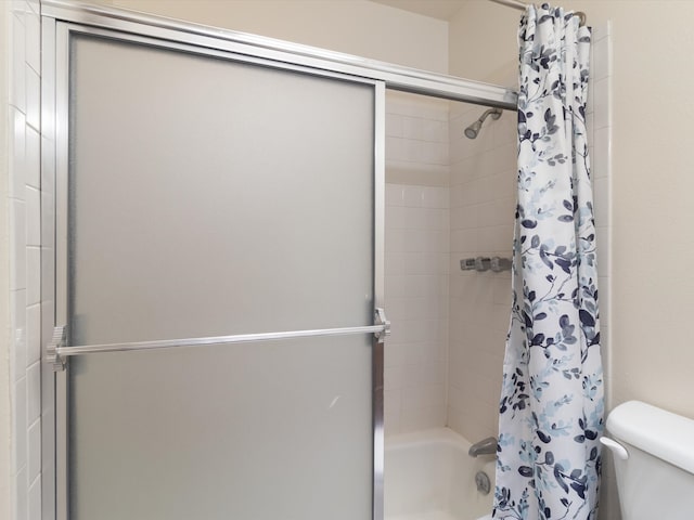 bathroom with shower / tub combo and toilet