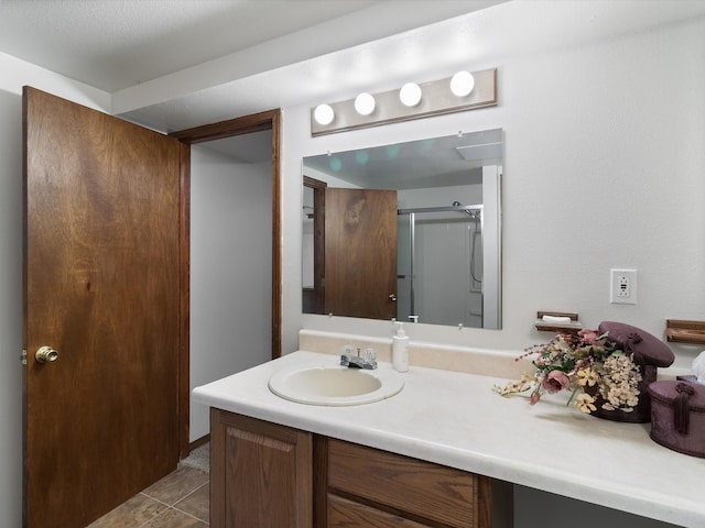 bathroom with tile patterned flooring, vanity, and an enclosed shower