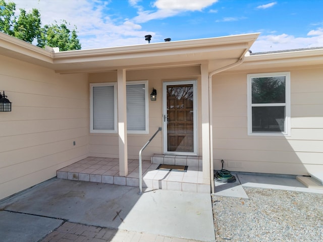 entrance to property featuring a patio