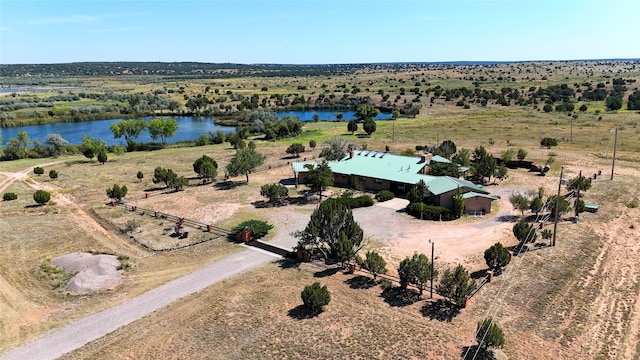 birds eye view of property featuring a water view and a rural view