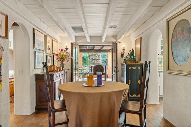 dining area featuring wood ceiling, hardwood / wood-style floors, and beamed ceiling