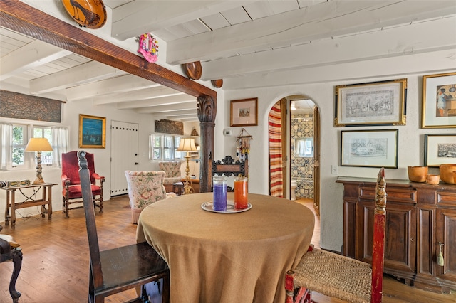 dining space featuring wooden ceiling, hardwood / wood-style floors, beamed ceiling, and plenty of natural light