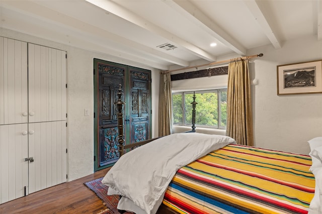 bedroom featuring access to exterior, dark wood-type flooring, and beam ceiling