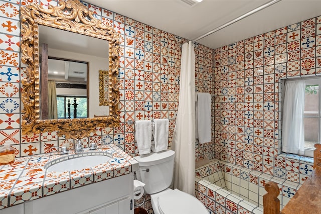 full bathroom with tile walls, vanity, a wealth of natural light, shower / tub combo with curtain, and toilet