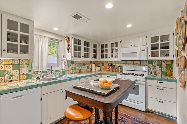 kitchen featuring white cabinets, white appliances, tile countertops, dark hardwood / wood-style floors, and sink