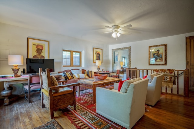 living room featuring wood-type flooring and ceiling fan