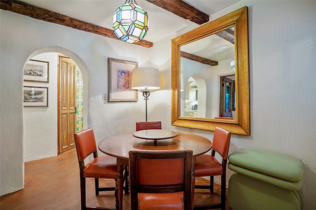 dining area with beam ceiling