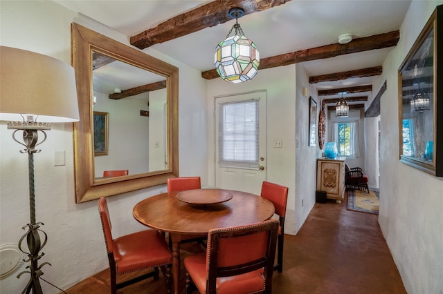 dining space with beamed ceiling and plenty of natural light