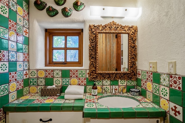 bathroom with decorative backsplash and vanity