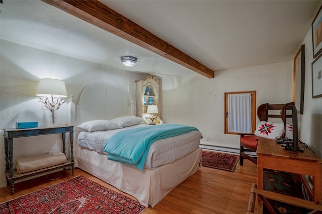 bedroom featuring light hardwood / wood-style floors, beamed ceiling, and a baseboard radiator