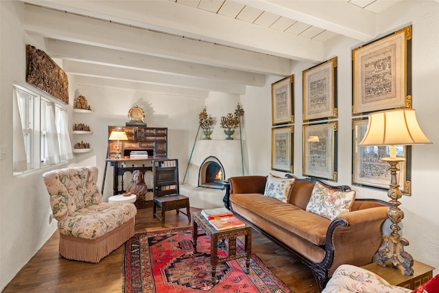 living room featuring dark wood-type flooring and beamed ceiling