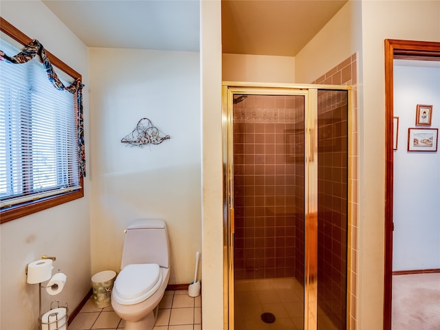 bathroom with toilet, a shower with door, and tile patterned floors