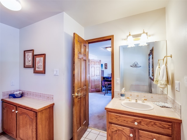 bathroom featuring decorative backsplash, tile patterned flooring, and vanity