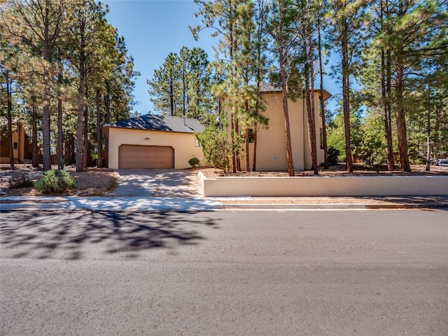 2176 La Tierra, Los Alamos, NM 87544 - view of front of house featuring a garage, driveway, and stucco siding