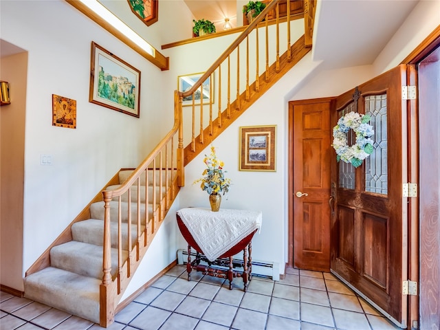 2176 La Tierra, Los Alamos, NM 87544 - foyer entrance featuring a baseboard radiator, light tile patterned flooring, and stairs