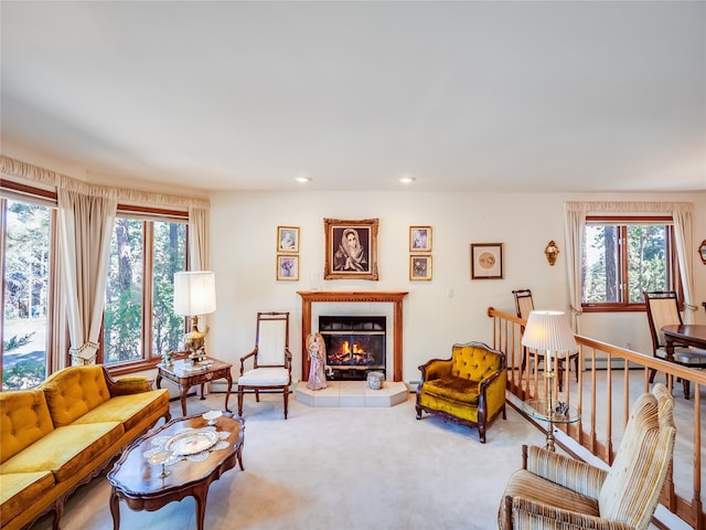 living room featuring a fireplace, carpet flooring, and a healthy amount of sunlight