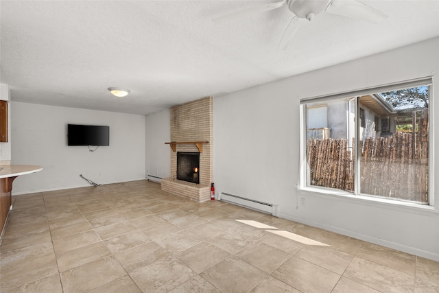 unfurnished living room with a textured ceiling, ceiling fan, a baseboard heating unit, and a brick fireplace