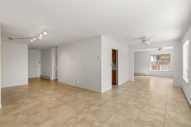 spare room featuring ceiling fan, a textured ceiling, and baseboard heating