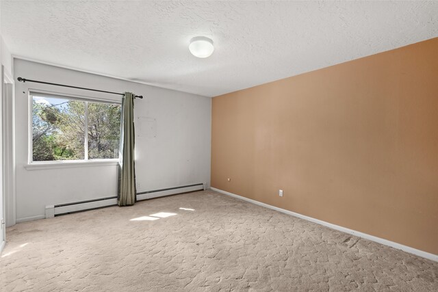 carpeted empty room featuring a textured ceiling and baseboard heating