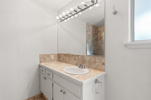 bathroom featuring a shower and vanity