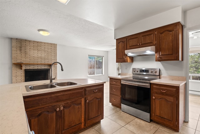 kitchen with stainless steel range with electric cooktop, a textured ceiling, light tile patterned floors, and sink