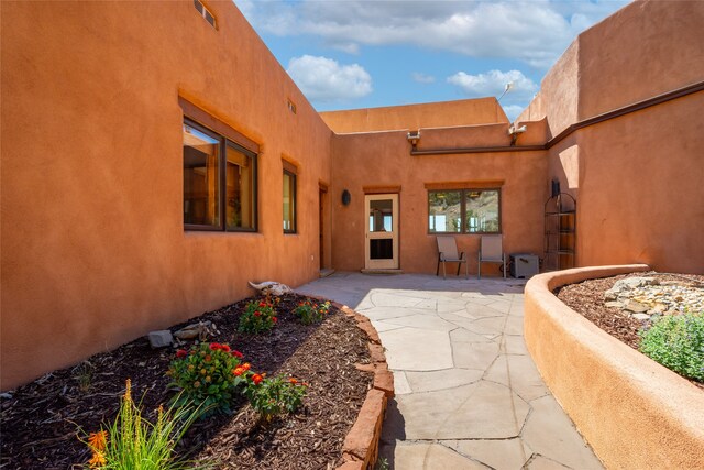 property entrance featuring a patio