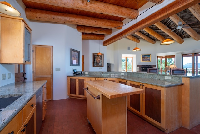 kitchen with ceiling fan, wood ceiling, wood counters, and a center island