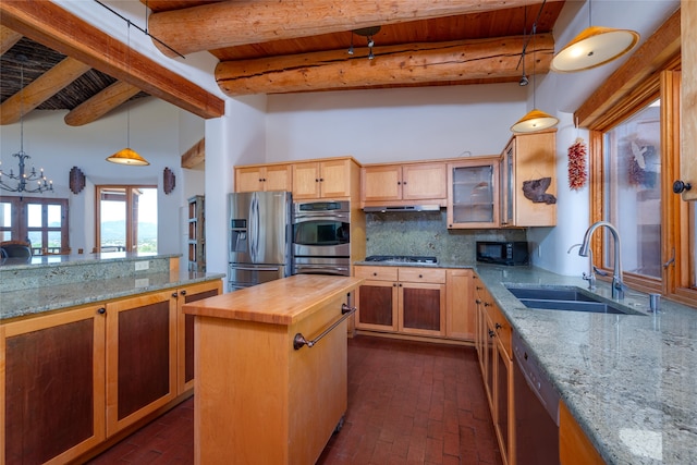 kitchen with beamed ceiling, sink, stainless steel appliances, a center island, and butcher block counters