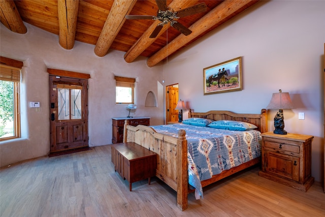 bedroom featuring ceiling fan, beamed ceiling, wood ceiling, and light hardwood / wood-style floors