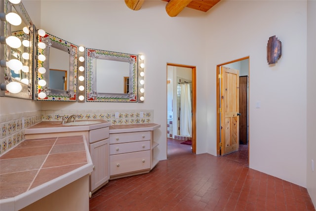 bathroom with vanity and a towering ceiling