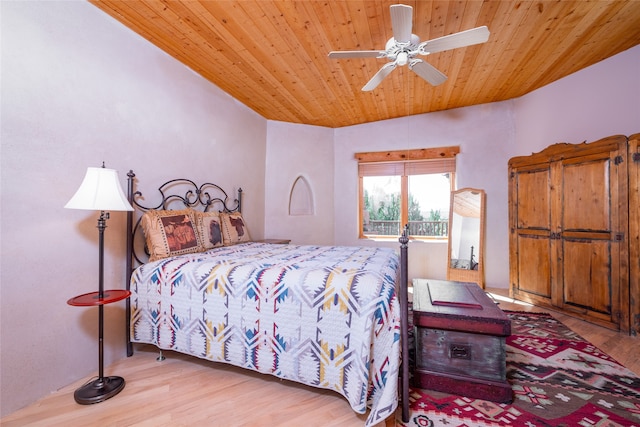 bedroom with light wood-type flooring, wood ceiling, vaulted ceiling, and ceiling fan