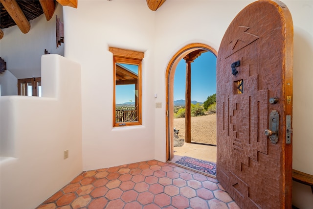 entryway featuring beamed ceiling