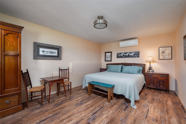 bedroom with dark hardwood / wood-style floors and a wall mounted air conditioner