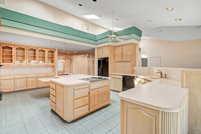 kitchen with sink, an island with sink, black appliances, light brown cabinets, and ceiling fan