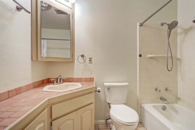 full bathroom featuring tile patterned floors, tiled shower / bath combo, vanity, and toilet