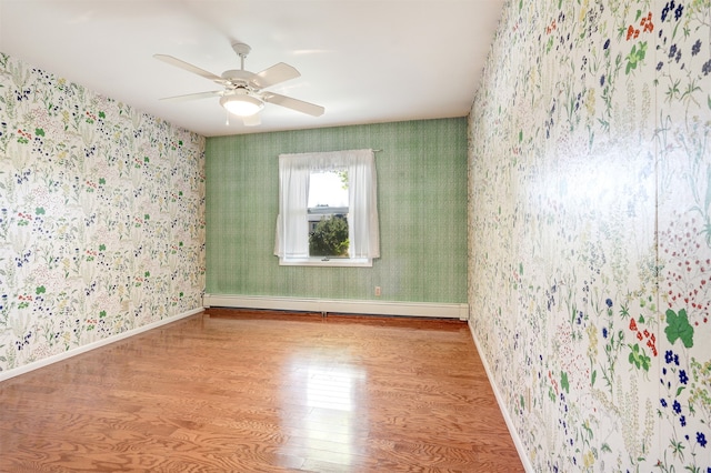 unfurnished room featuring a baseboard radiator, light hardwood / wood-style floors, and ceiling fan