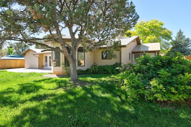 back of house with a lawn