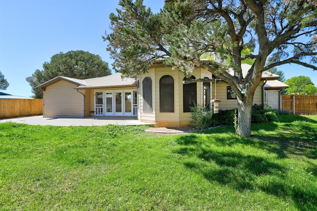 back of house featuring a yard