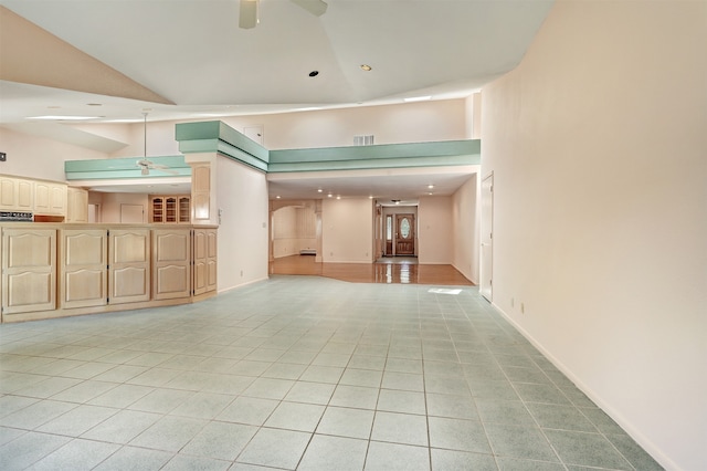 spare room with high vaulted ceiling, ceiling fan, and light tile patterned flooring