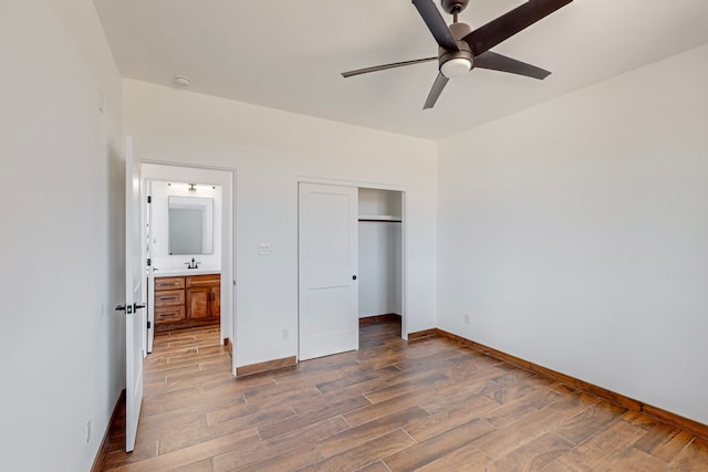 unfurnished bedroom with ceiling fan, sink, and a closet