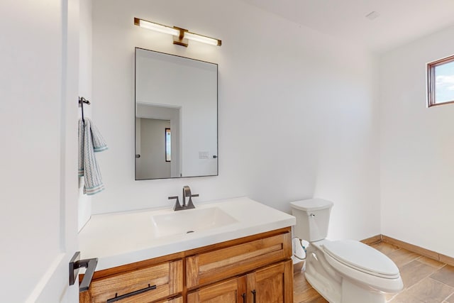 bathroom with vanity, wood-type flooring, and toilet