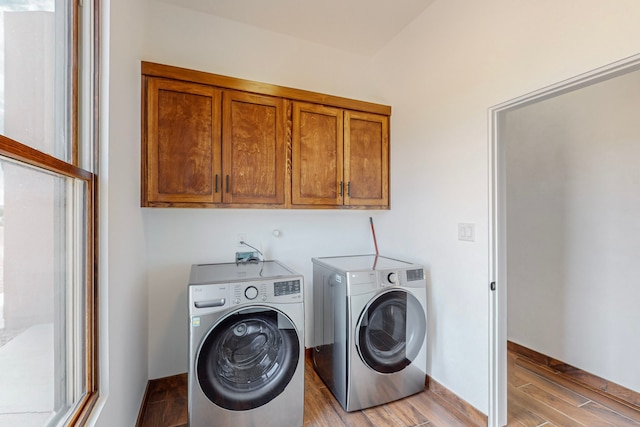 laundry room featuring cabinets and washing machine and clothes dryer