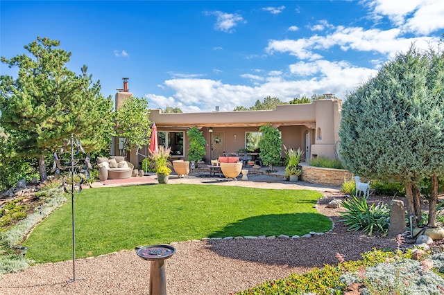 back of house featuring a yard and a patio