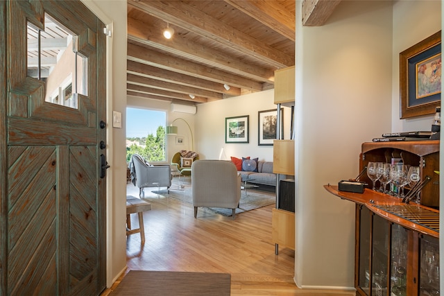 hall with beam ceiling and light hardwood / wood-style floors